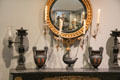 Convex mirror, Argand lamps & Greek-style vases on mantle in Chillman Parlor at Bayou Bend. Houston, TX.
