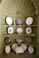 Corner cabinet with ceramic plates & bowls in Newport room at Bayou Bend. Houston, TX.