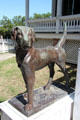 Cast dog statue before Pilot House at Sam Houston Park. Houston, TX.