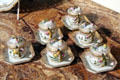 Porcelain Royal Copenhagen 'Flora Danica' custard cups on octagonal saucers 20th C at Rienzi house museum. Houston, TX.