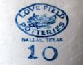 Brand stamp for Love Field Potteries of Dallas, Texas with picture of biplane on stoneware crock at Sauer-Beckmann Farmstead. Stonewall, TX.