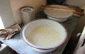 Letting milk set in open pan for cheesemaking at Sauer-Beckmann Farmstead. Stonewall, TX.