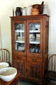 Cabinet with dishes at Sauer-Beckmann Farmstead. Stonewall, TX.