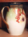Gold & red ceramic Pickard? pitcher at Fort House. Waco, TX.