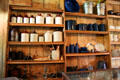Crock & metalware shelves in Commissary at historic village of Mayborn Museum. Waco, TX.