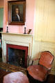 Fireplace & armchair at French Legation Museum. Austin, TX.
