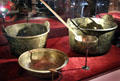 Brass cooking pots, ladle & colander excavated from La Belle Shipwreck at Bullock Texas State History Museum. Austin, TX