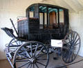 Texas Mud Wagon a stage coach good for muddy roads in Wagon Shop at Pioneer Farms. Austin, TX.