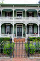 Cast iron fence & verandah details of Ilse-Rau House. Columbus, TX.