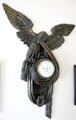 Carved eagle holding drapery framing clock at Museum of Texas Handmade Furniture. New Braunfels, TX.