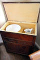 Interior of chamber washstand with bowl & pitcher & storage space at Museum of Texas Handmade Furniture. New Braunfels, TX.