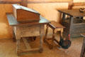 Chickens climb through desk in storehouse at Jamestown Settlement. Jamestown, VA.