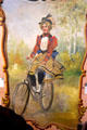 Carousel painted panel of woman on bicycle in circus building at Shelburne Museum. Shelburne, VT.