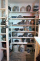 Pantry with stoneware crocks, glassware & metalware at Billings Farm & Museum. Woodstock, VT.