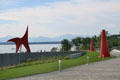 Path of Olympic Sculpture Park zigzags down to Elliott Bay with Olympic mountain ranges in distance. Seattle, WA.