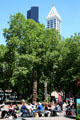 Sidewalk cafe in Occidental Park with Smith Tower & Columbia Center beyond. Seattle, WA.