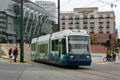 SoundTransit streetcar rolls past Tacoma Convention & Trade Center. Tacoma, WA.