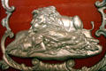 Carving of lion guarding sleeping woman on red & silver circus wagon at Circus World Museum. Baraboo, WI.