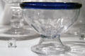 Footed blown lead glass bowl with cobalt blue applied glass lip from Pittsburgh, PA in glass gallery at Huntington Museum of Art. Huntington, WV.