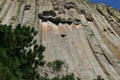Exterior columns fall away to reveal clean columns underneath Devils Tower. WY.