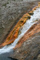 Colored deposits along Excelsior Geyser outflow stream at Yellowstone National Park. WY.