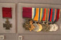 Victoria Cross medals with red ribbons plus others from WWI at Museum of Liverpool. Liverpool, England.