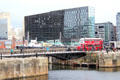 Heritage double decker bus converted to diner with new highrises surrounding Liverpool port attractions. Liverpool, England.