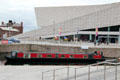 Canal boat passes Museum of Liverpool. Liverpool, England.