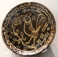 Glazed earthenware plate with slip rooster decoration prob. from Staffordshire at Walker Art Gallery. Liverpool, England.