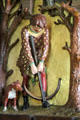 Carving of man pulling crossbow with dog in Winter Smoking Room at Cardiff Castle. Cardiff, Wales.