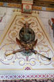 Painted stone chimneypiece with the figure of Fame & her herald holding two trumpets representing "great renown" or "ill fame" carved by sculptor, Thomas Nicholls in Day Nursery at Cardiff Castle. Cardiff, Wales.