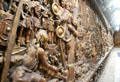 Roman Invasion of South Wales sculpted mural of cement & plaster finished in metallic gold paint by Frank Abraham at Cardiff Castle,. Cardiff, Wales