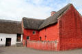 Red painted Kennixton Farmhouse with straw roof at St Fagans National Museum of History. Cardiff, Wales.