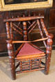 Vintage three legged wooden stool with arms in St Fagans Castle. Cardiff, Wales.