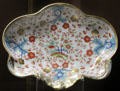 Hybrid-paste porcelain scalloped-shaped dish with floral design made by Chamberlain of Worcester at National Museum of Wales. Cardiff, Wales.
