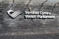 Sign for Senedd Cymru with dragon, the symbol of Wales, at Cardiff Bay. Cardiff, Wales.