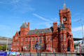 Western facade of the Pierhead building now belonging to the Senedd Cymru with exterior of red glazed terracotta blocks at Cardiff Bay. Cardiff, Wales.