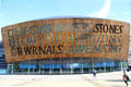 The English inscription on front of the dome reads "In These Stones Horizons Sing" by Welsh poet, Gwyneth Lewis at Wales Millennium Centre at Cardiff Bay. Cardiff, Wales.