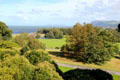 View of grounds with Irish Sea in the distance at Penrhyn Castle. Bangor, Wales.