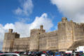 Immense walls, designed to withstand assault, at Caernarfon Castle. Caernarfon, Wales.