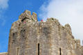 Details of polygonal tower, arrow slits and crenellations at Caernarfon Castle. Caernarfon, Wales.