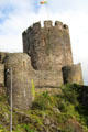 Tower with Welsh flag flying & part of wall of Conwy Castle. Conwy, Wales.