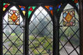 Window with stained glass panels looking out to garden at Plas Newydd. Llangollen, Wales.