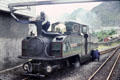 Putting water into Blaenau Ffestiniog Railway steam engine sitting on narrow gauge track. Blaenau Ffestiniog, Wales.
