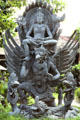 Carved multihanded god over winged garuda at house of a prince. Bali, Indonesia.
