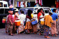 Vendors rally around tourist vans. Bali, Indonesia.