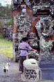 Woman leaving offering at temple. Bali, Indonesia.