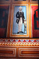 Portrait of a prosperous Indian in Victorian dress on a haveli wall. Mandawa, India.