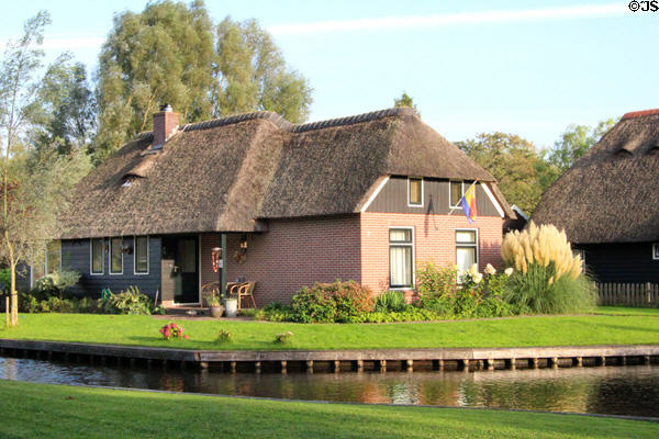 Home with thatched roof on canal. Giethoorn, Netherlands.