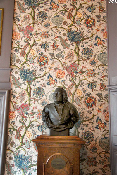 Male bust against a pattern of floral wall paper in home of Pieter Teyler at Teylers Museum. Haarlem, Netherlands.